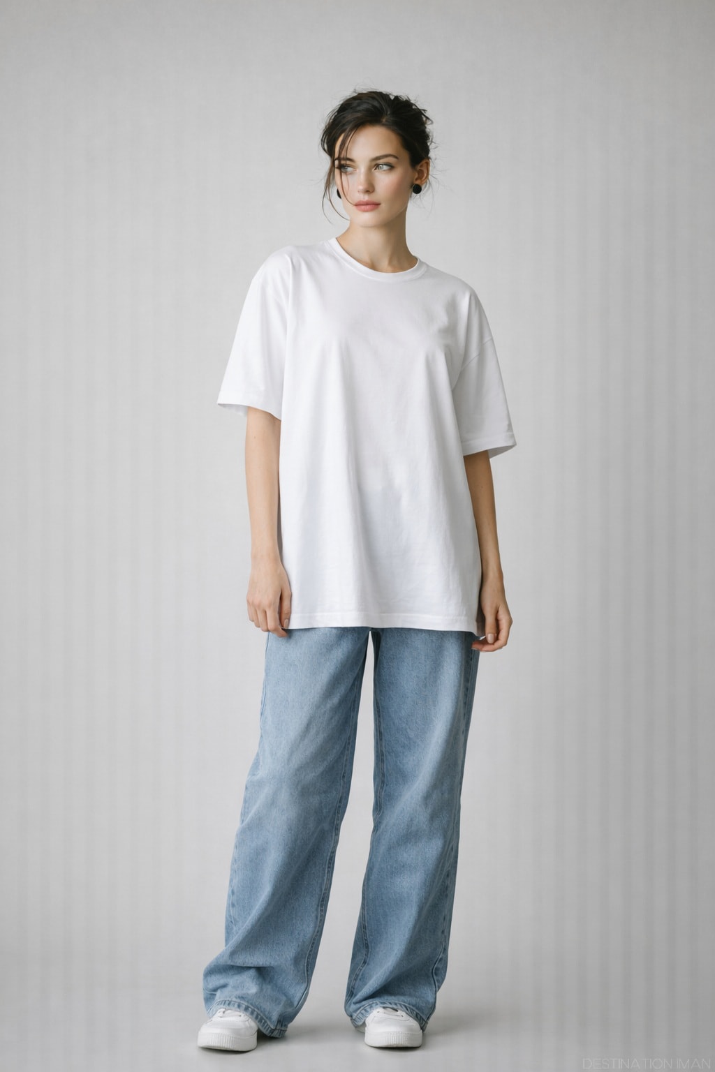Oversized loose clothing creating a shapeless silhouette and adding visual volume in a full-body portrait