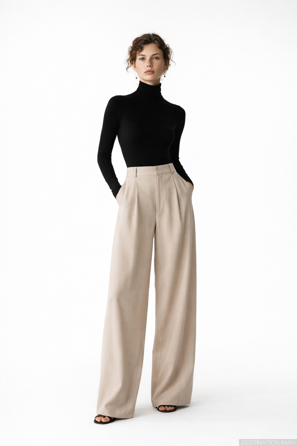 Woman wearing fitted black turtleneck with relaxed beige wide-leg trousers demonstrating perfect proportion balance
