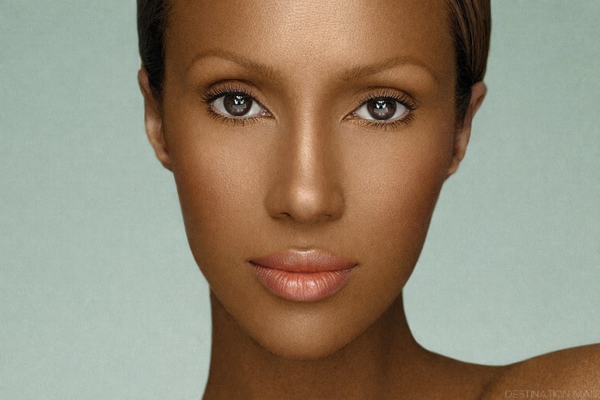 High-resolution close-up portrait of Iman with natural makeup, smooth skin, and soft studio lighting on a neutral background