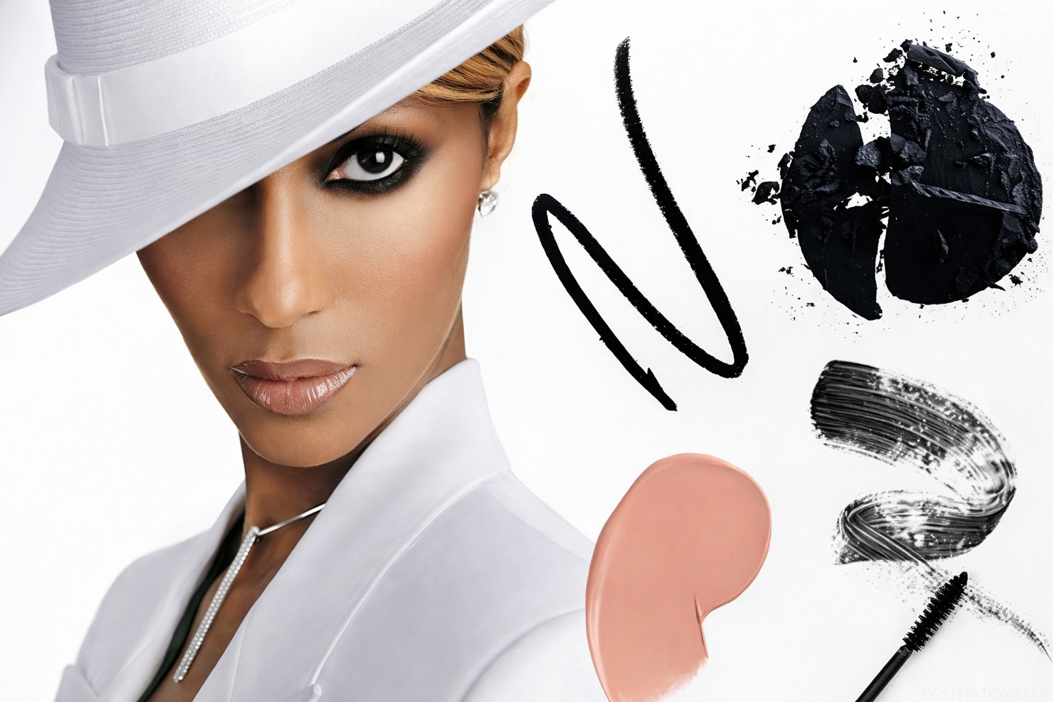 Fashion portrait of model Iman wearing a white hat with elegant makeup on a clean white background