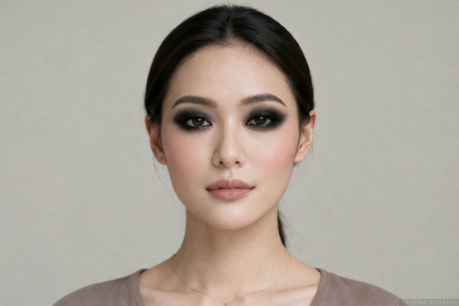 Portrait demonstrating overly dark and unbalanced eye makeup that creates heavy shadows and makes eyes appear smaller in photography
