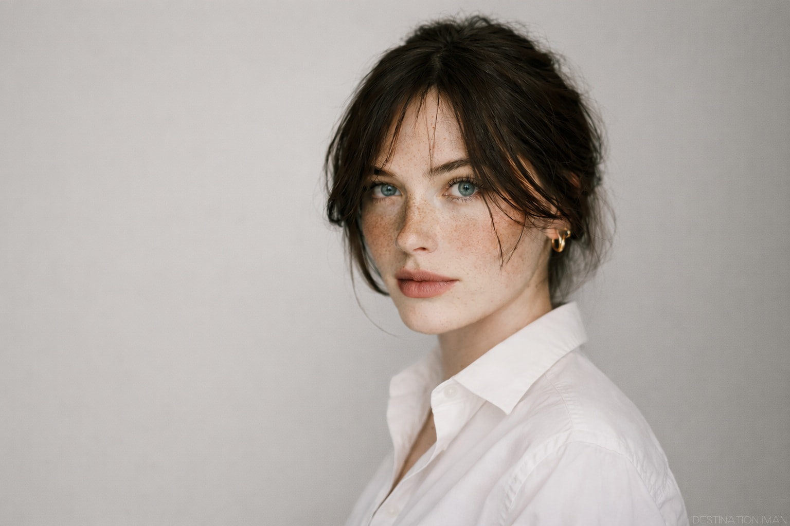 A neutral, softly lit portrait with restrained composition and negative space, expressing timeless beauty through balance, calm presence, and visual restraint beyond fashion or era.